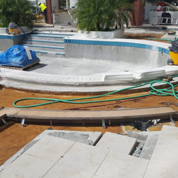 combination of curved and straight trench drain at a pool