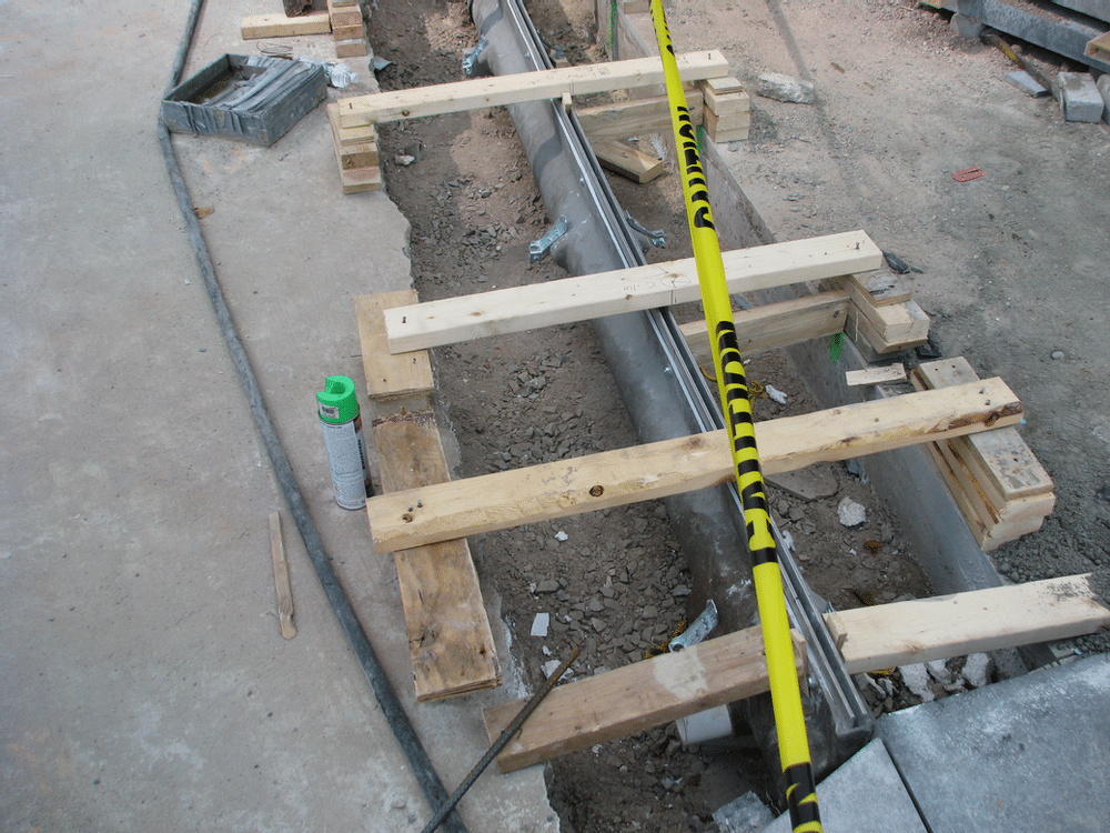 Narrow reveal slot drain practically disappears once paving stone is installed.