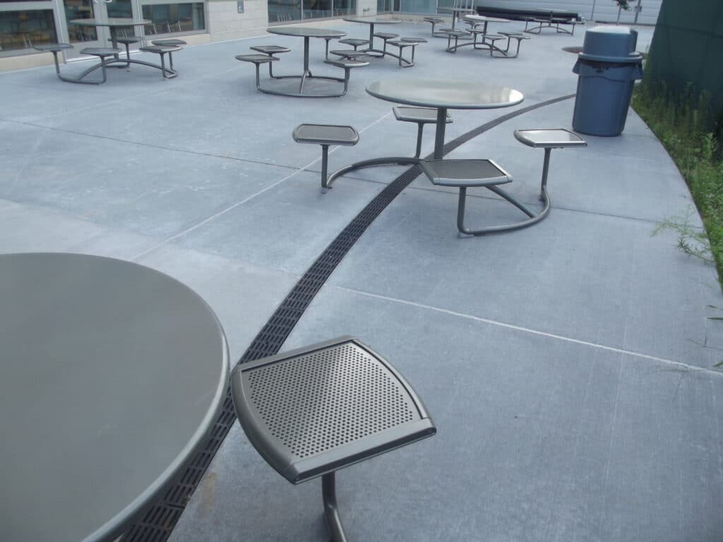Patio seating area with radius trench drain