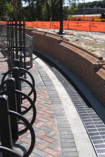 Curved trench drain at park retaining wall