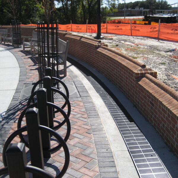 Curved trench drain at park retaining wall