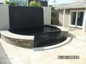 Water feature radius trench drain