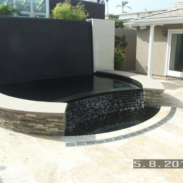 Water feature radius trench drain