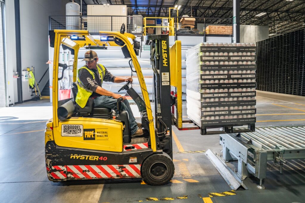 man using a forklift in a brewery on top of heavy duty trench drain